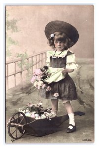 Postcard Young Girl Wheelbarrow Flowers Easter Eggs Hand Colored RPPC B.N.K. #1