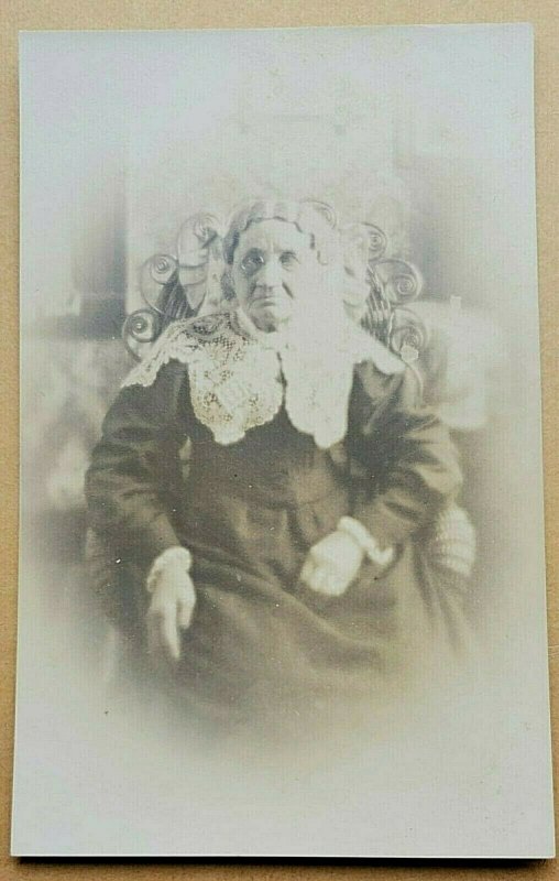 1910 RPPC Postcard Cross-eyed or Blind Elderly Woman Stoic in Wicker Chair