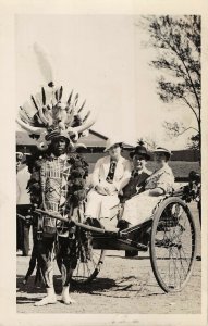 African warrior pulling tourist cart c1940 RPPC aj 228