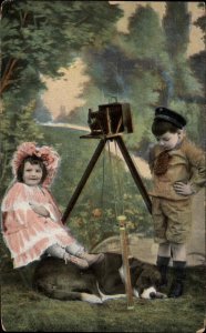 Little Boy and Girl w Dog and Old Camera PHOTO SHOOT c1910 Postcard