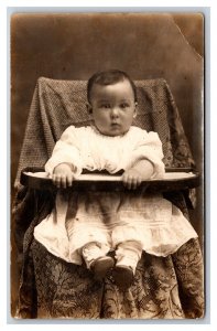 RPPC Adorable Bewildered Baby Sitting in High Chair Studio View UNP Postcard H18