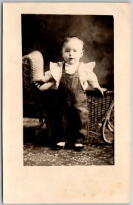 1908 Infant Cute Little Boy Rattan Chair Behind Real Photo RPPC Posted Postcard