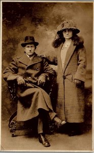 c1900 SOMBER WELL DRESSED COUPLE  UNDIVIDED REAL PHOTO POSTCARD  17-22 