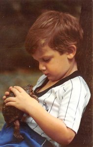 Little boy holding a turtle Children Unused 