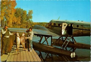 Postcard SK Lac la Ronge Fishermen Huge Fish & Norcanair Hydroplane 1974 K56 