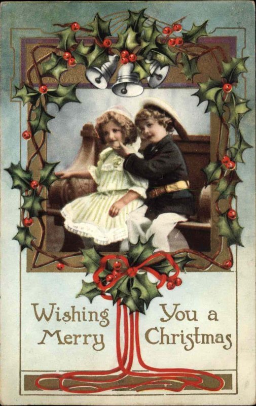 Christmas Boy Girl at Church Holly Bells Gilt Embossed c1910 Vintage Postcard