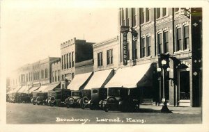 Postcard RPPC Kansas Larned Broadway automobiles 1907 23-6084