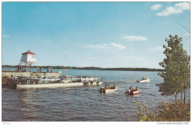 Auto Ferry passes small Lighthouse , Lac des Deux-Montagnes , Quebec , Canada...