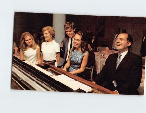 Postcard Richard Nixon with his family playing a piano