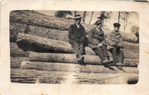 J25/ West Branch Michigan RPPC Postcard c1910 People Sitting Log Pile 195