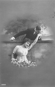 Love Romance 1914 Man Kisses Lady's Hand Flowers RPPC vintage postcard B917