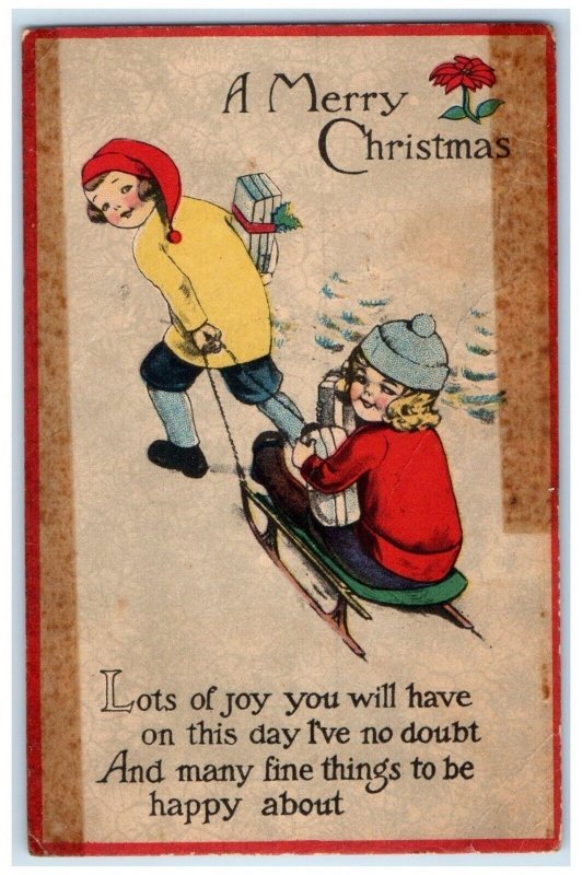 1915 Merry Christmas Children Sledding In Winter With Gift Waterloo IA Postcard