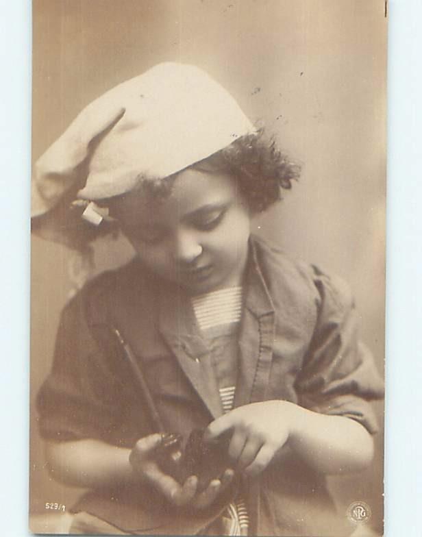 1907 rppc YOUNG GIRL PUTTING YOUR FINGER INTO TOBACCO PIPE HM1036