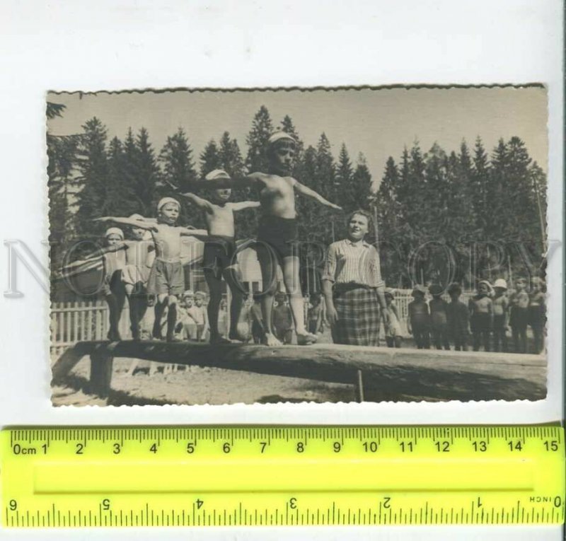 452658 USSR pioneer camp children walk on a log Old photo