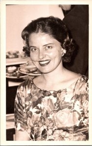 RPPC Postcard of Smiling Woman in Floral Dress Sitting at Table