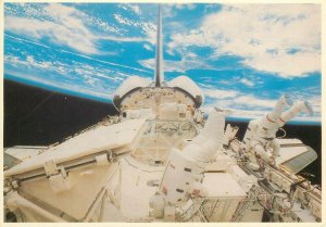 Astronauts performing extra vehicular activity in space postcard shuttle