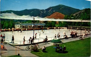 Olympic Size Ice Rink Sun Valley Idaho skaters, bicycles, mountains Postcard