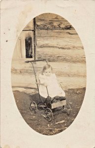 CUTE YOUNG BABY GIRL IN PUSH CHAIR STROLLER~1910s REAL PHOTO POSTCARD