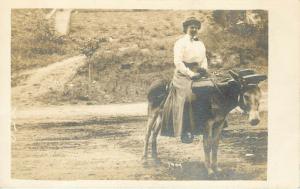 RPPC Postcard Woman on Trail Rides a Hat Wearing Donkey