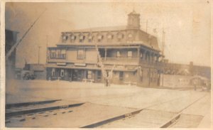 H74/ Interesting RPPC Postcard c1910 Railroad Depot Station Crossing 203