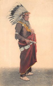 INDIAN WITH GUN HAND COLORED POSTCARD 1906