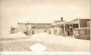 RPPC WAUSA?, NE Nebraska  Snowy  Street Scene   HARDWARE STORE c1910s  Postcard