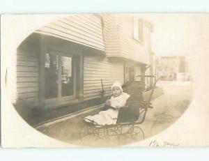 Pre-1917 rppc BABY WITH STUNNED LOOK ON FACE IN BABY CARRIAGE o2359