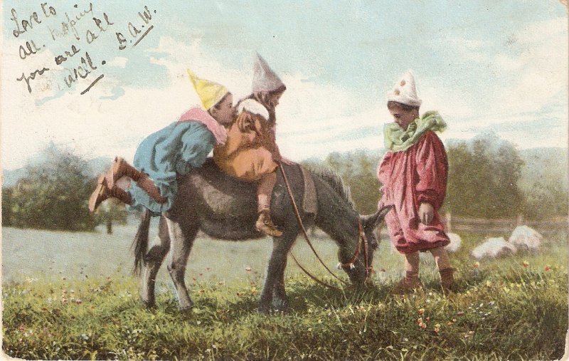 Clown dressed children pl,aying with donkey  Old vintage English PC