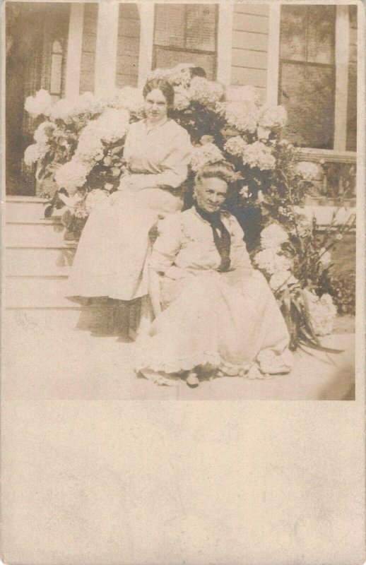 c.1908 Women Sitting on House Steps Hydrangea Bush Real Photo Postcard 10C1-419