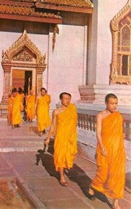 Priests out from temple hall after daily sutra Bangkok Thailand Unused 