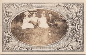 RPPC Postcard Men + Women Fancy Clothes Sitting on Grass