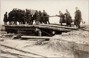 Soldiers Pushing Wagon Military WW1 Unknown Location Real Photo Postcard G25