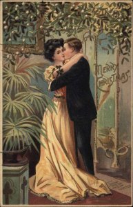 Christmas Boy and Girl Kissing Under Mistletoe c1910 Vintage Postcard