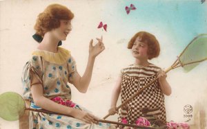 Two girls playing with the butterfly Writing on Back