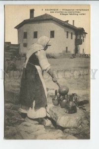 439441 Greece Thessaloniki Salonique woman water carrier pours water over a jug