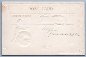 1910's CHRISTMAS BOY ROLLS WORRIED SNOWMAN HEAD EMBOSSED ANTIQUE POSTCARD