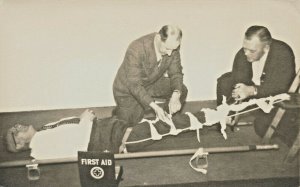 Applying First Aid on A Stretcher A Dupont Real Photo Postcard