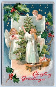 1910's TUCK'S*CHRISTMAS GREETINGS*ANGELS TRIMMING TREE*CANDLES*EMBOSSED*POSTCARD