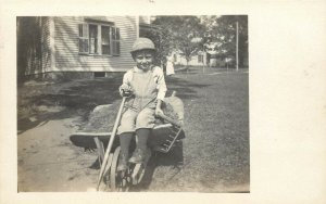 RPPC Cute Little Boy in Coveralls Sits in Wheelbarrow W Rake & Shovel Labor Day