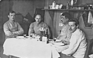 GERMAN ? WW1 SOLDIERS SITTING AT TABLE DRINKING WINE-PHOTO POSTCARD