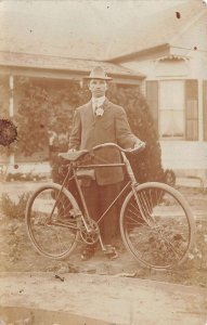 Man posing with Bicycle Postal Used Real Photo Vintage Postcard AA111303