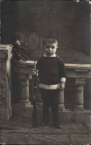 Serious Little Boy with Gun Rifle and Toy Monkey Real Photo RPPC c1910 PC