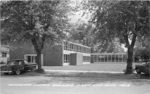 Autos 1955 Missaukee County Building RPPC Postcard Lake City Michigan 13618