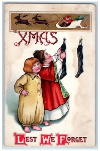 c1910's Christmas Girls Hanging Stockings Santa Claus Reindeer Embossed Postcard
