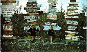 WATSON LAKE, Yukon, Canada Cute Kids MULTIPLE SIGN POSTS 1958 Roadside  Postcard