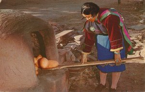 Native American Woman Baking Bread in Adobe Outdoor Oven NM, New Mexico