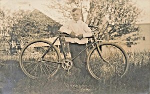 PROUD YOUNG BOY POSES WITH TOO TALL BICYCLE~1910s REAL PHOTO Postcard