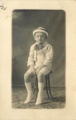 REAL PHOTO-SLOUCHING LITTLE BOY  WEARING BOWTIE-K34499