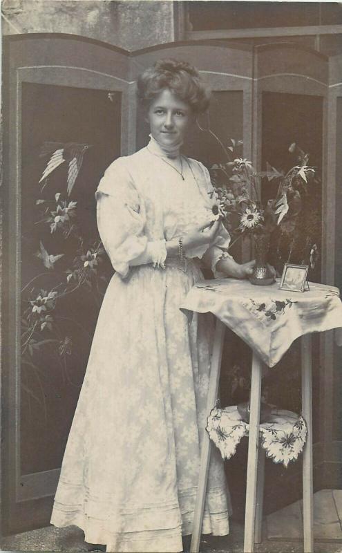 Women portraits near tall table early photo postcards x 2