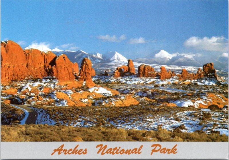 Postcard Arches National Park - Winter snow covering the Windows Section